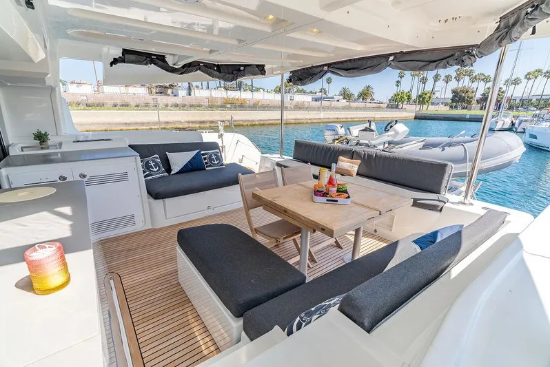 Flying B Yacht Photos Pics Luxurious Lagoon 46 yacht interior, 2021 model, featuring elegant seating and dining area by the water.
