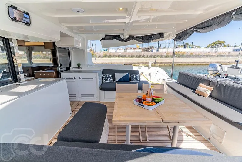 Flying B Yacht Photos Pics Luxurious Lagoon 46 catamaran interior, 2021 model, featuring elegant seating and dining area.