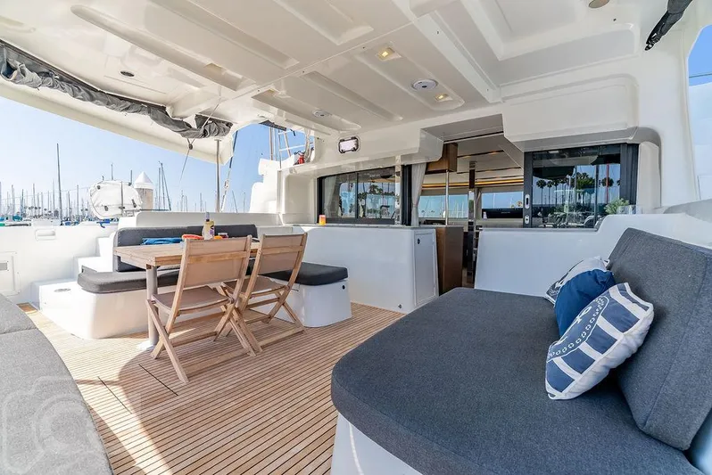 Flying B Yacht Photos Pics Spacious deck of 2021 Lagoon 46 catamaran with seating and dining area.