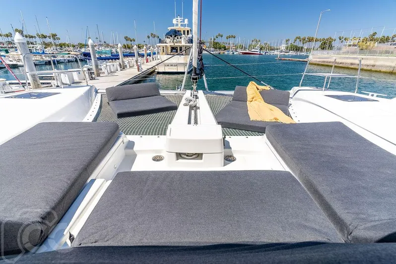 Flying B Yacht Photos Pics Luxurious Lagoon 46 catamaran, 2021 model, docked at a sunny marina.