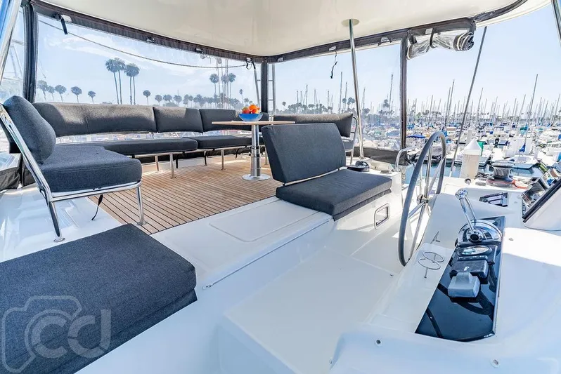 Flying B Yacht Photos Pics Luxurious 2021 Lagoon 46 yacht interior with modern seating and marina view.