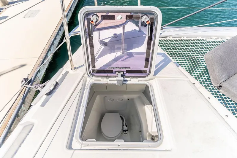 Flying B Yacht Photos Pics Hatch on Lagoon 46 catamaran deck revealing a compact marine toilet.