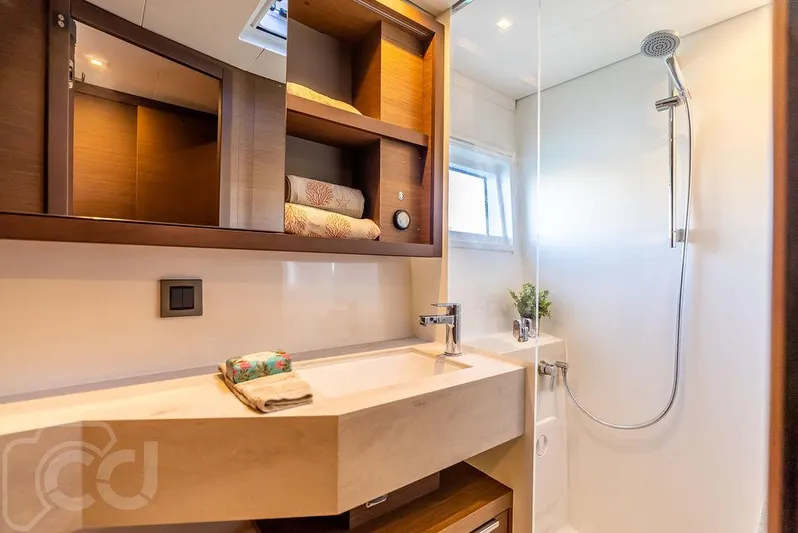 Flying B Yacht Photos Pics Modern bathroom in 2021 Lagoon 46 yacht with shower and wooden shelving.