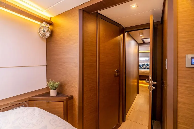 Flying B Yacht Photos Pics Luxurious interior of 2021 Lagoon 46 yacht, featuring wood paneling and modern design.