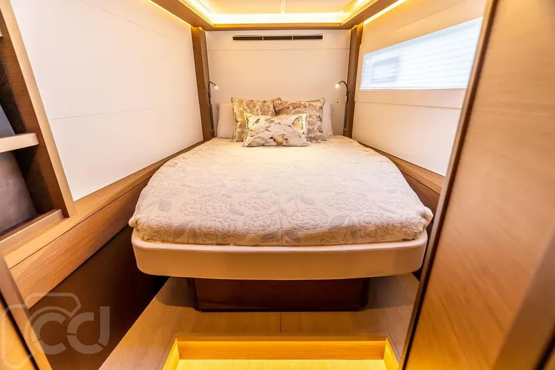 Flying B Yacht Photos Pics Luxurious cabin interior of 2021 Lagoon 46 yacht with cozy bed and ambient lighting.