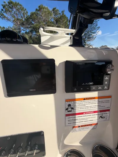  Yacht Photos Pics 2024 Cobia 240 Center Console dashboard with Yamaha and JL Audio equipment.