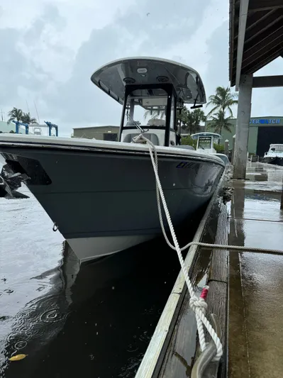  Yacht Photos Pics 2024 Cobia 240 Center Console boat docked in rainy weather.