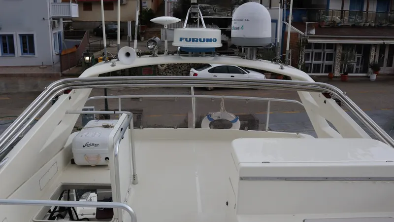 1522 Yacht Photos Pics 1997 Ferretti Yachts 60 Flybridge deck with navigation equipment and city backdrop.