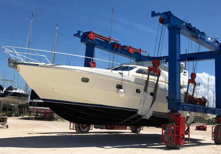 1522 Yacht Photos Pics 1997 Ferretti Yachts 60 Flybridge being lifted by a boat hoist.