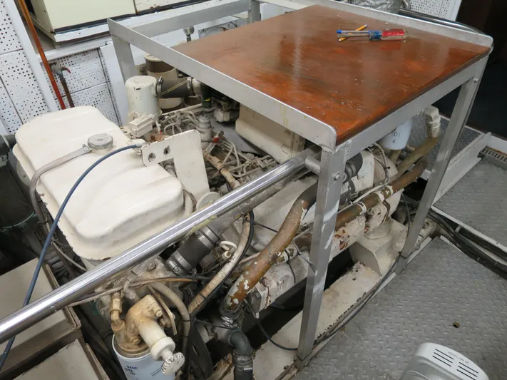 Water Doctor Yacht Photos Pics Engine room of a 1988 DeFever 53POC yacht, featuring mechanical components and tools.