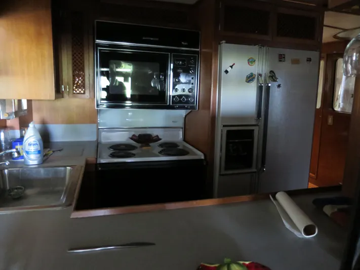 Water Doctor Yacht Photos Pics 1988 DeFever 53POC yacht kitchen with stove, oven, and refrigerator.