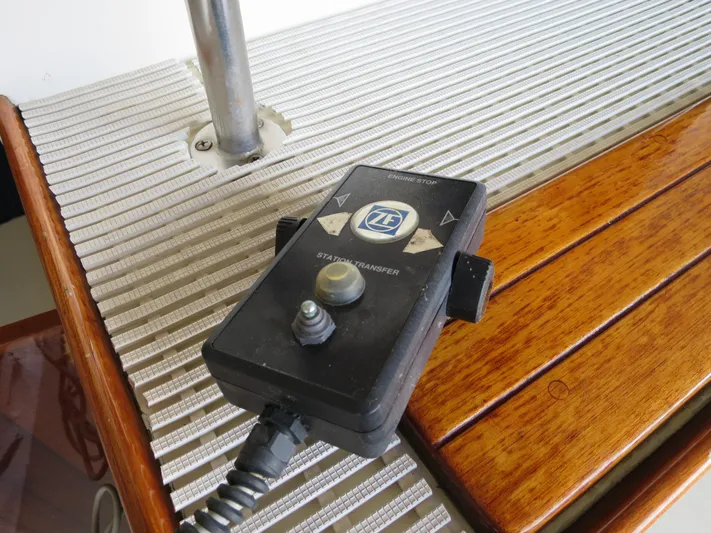 Water Doctor Yacht Photos Pics Remote control on DeFever 53POC yacht, 1988 model, placed on wooden and metal surface.