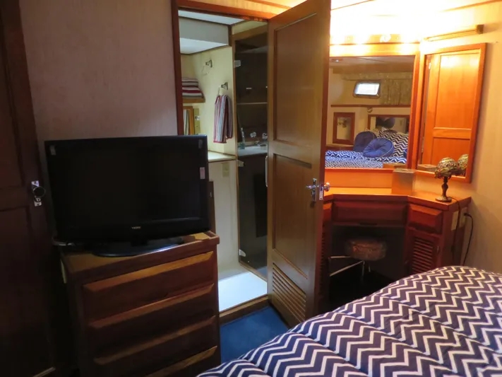 Water Doctor Yacht Photos Pics Interior of 1988 DeFever 53POC yacht with bedroom, TV, and vanity area.