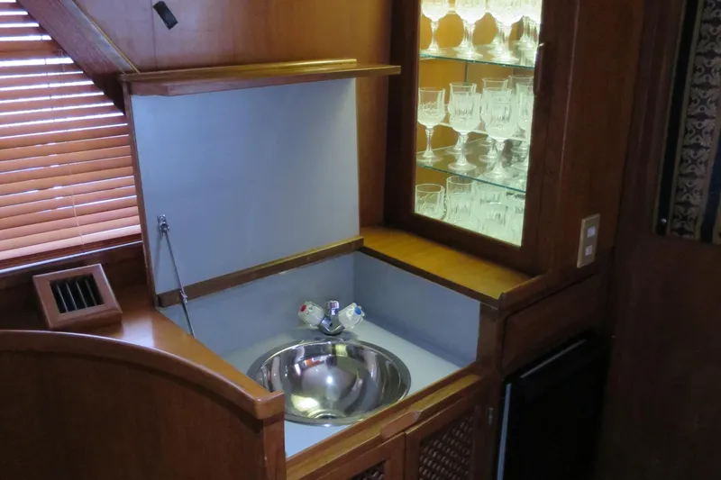 Water Doctor Yacht Photos Pics 1988 DeFever 53POC yacht interior with sink and glass cabinet.