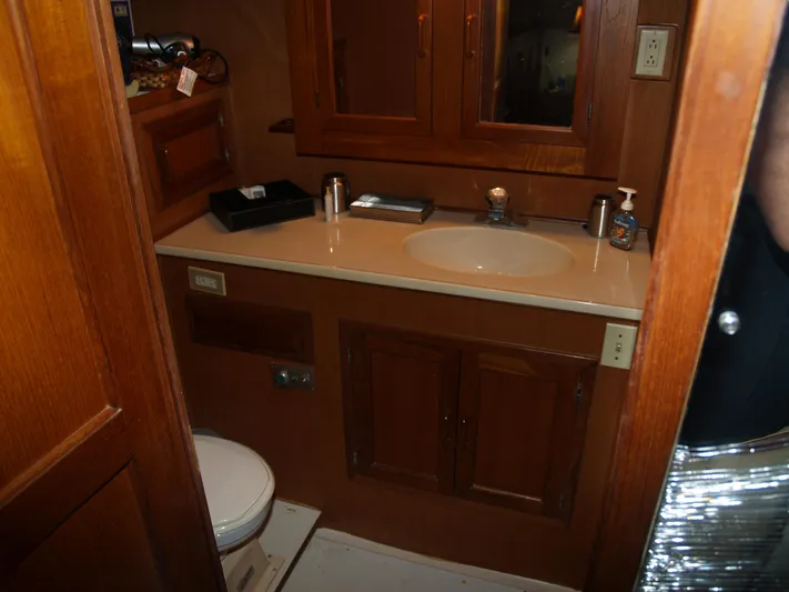 Water Doctor Yacht Photos Pics 1988 DeFever 53POC yacht bathroom with wooden cabinets and sink.