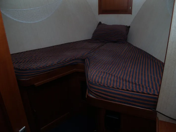 Water Doctor Yacht Photos Pics 1988 DeFever 53POC cabin with striped bedding and wooden interior.