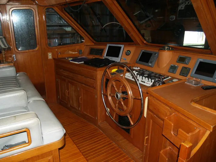 Water Doctor Yacht Photos Pics 1988 DeFever 53POC yacht helm with wooden interior and navigation equipment.