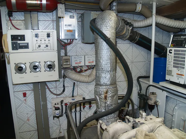 Water Doctor Yacht Photos Pics Engine room of 1988 DeFever 53POC yacht with control panels and insulated pipes.