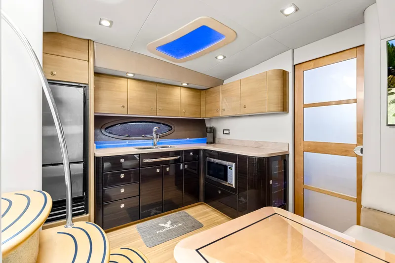 Black Diamond Yacht Photos Pics Luxurious kitchen interior of 2016 Formula 45 Yacht with modern appliances and sleek cabinetry.