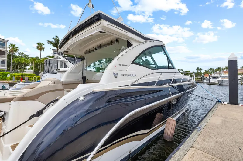 Black Diamond Yacht Photos Pics 2016 Formula 45 Yacht docked at marina, clear sky, palm trees in background.