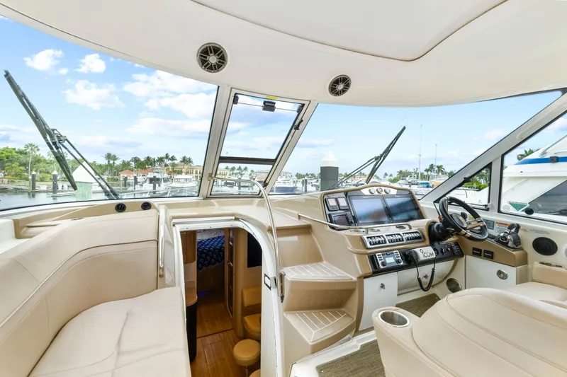 Black Diamond Yacht Photos Pics Interior of 2016 Formula 45 Yacht with helm, seating, and marina view.