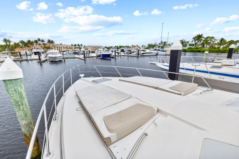 Black Diamond Yacht Photos Pics 2016 Formula 45 Yacht docked in a scenic marina with palm trees and blue sky.