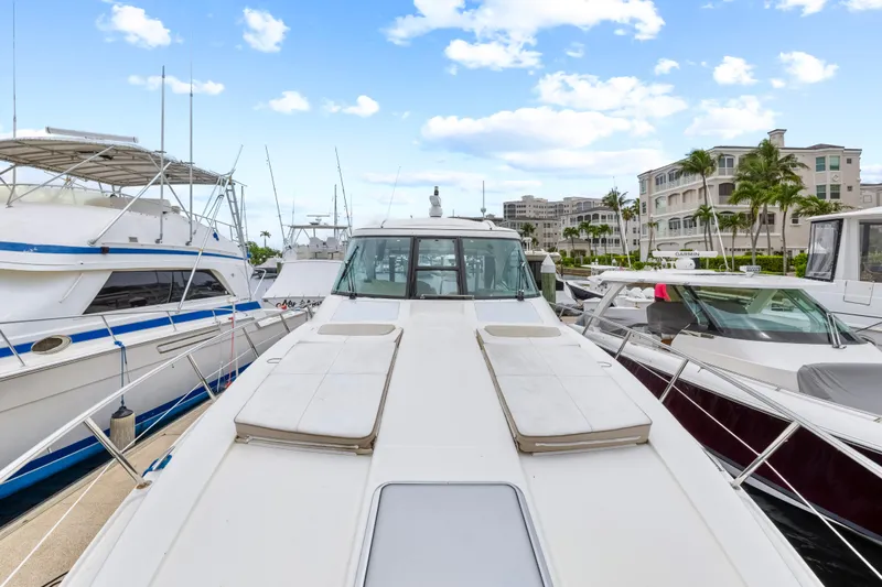 Black Diamond Yacht Photos Pics 2016 Formula 45 Yacht docked at marina, surrounded by other boats, under a clear blue sky.