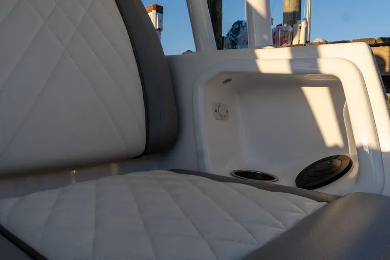 Almost Heaven Yacht Photos Pics 2024 Everglades 395 Center Console interior with quilted seating and storage compartment.