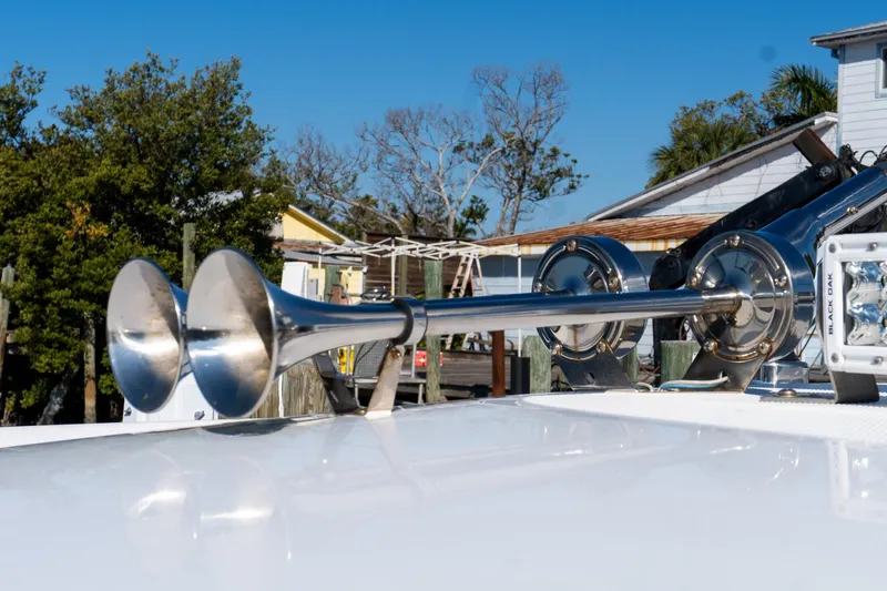 Almost Heaven Yacht Photos Pics 2024 Everglades 395 Center Console boat horn detail with clear blue sky background.