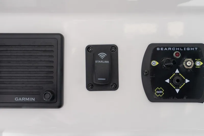 Almost Heaven Yacht Photos Pics Control panel of 2024 Everglades 395 Center Console with Garmin, Starlink, and searchlight controls.