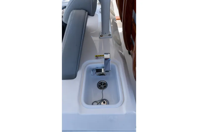 Almost Heaven Yacht Photos Pics 2024 Everglades 395 Center Console boat sink with chrome faucet and drain plug.