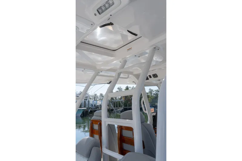 Almost Heaven Yacht Photos Pics Interior view of 2024 Everglades 395 Center Console boat, showcasing seating and structure.