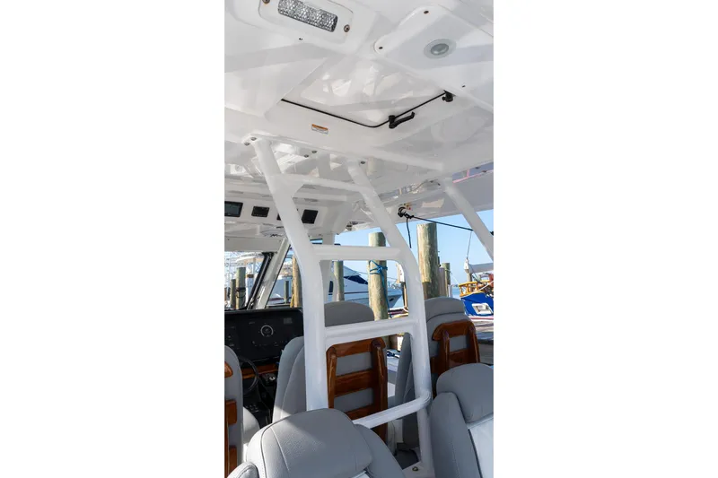 Almost Heaven Yacht Photos Pics 2024 Everglades 395 Center Console interior with seating and helm station.