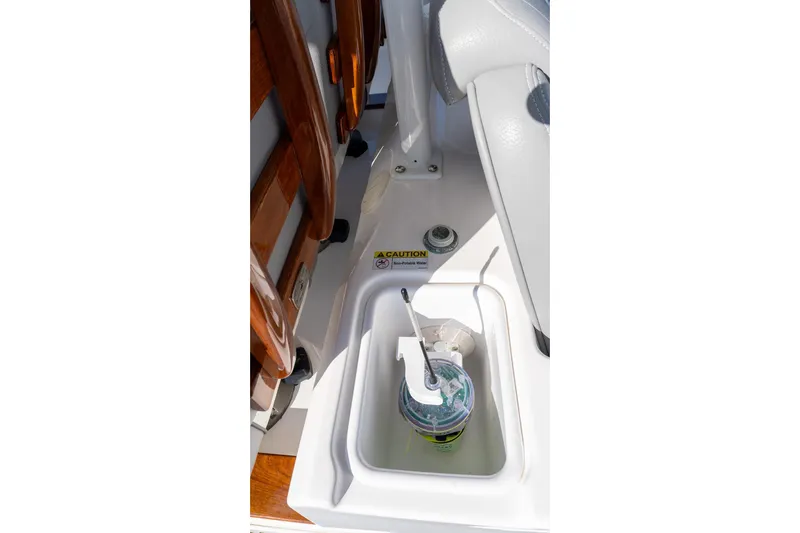 Almost Heaven Yacht Photos Pics 2024 Everglades 395 Center Console boat interior with cup holder and caution label.