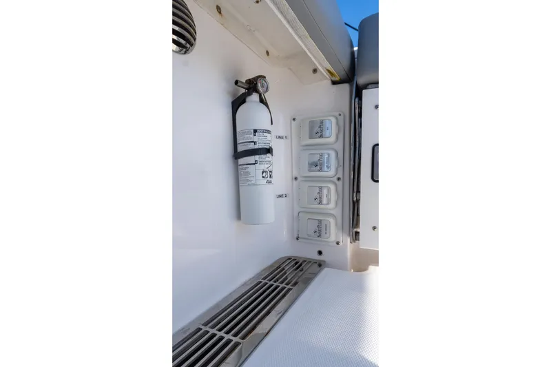 Almost Heaven Yacht Photos Pics 2024 Everglades 395 Center Console interior with fire extinguisher and control panel.