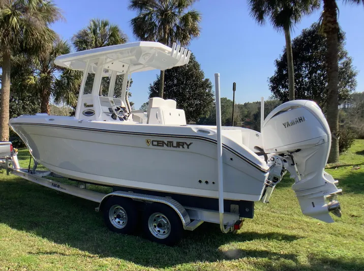 Highly Upgraded - 2025 Century 2600 Cc Yacht Photos Pics 2025 Century 2600 Center Console boat on trailer, surrounded by palm trees.