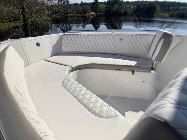 Highly Upgraded - 2025 Century 2600 Cc Yacht Photos Pics Luxurious seating on 2025 Century 2600 Center Console boat by a serene lake.