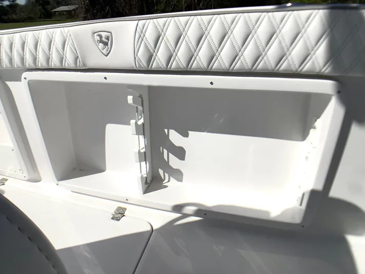 Highly Upgraded - 2025 Century 2600 Cc Yacht Photos Pics 2025 Century 2600 Center Console boat with white quilted interior and storage compartment.