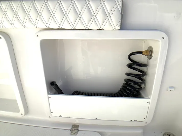 Highly Upgraded - 2025 Century 2600 Cc Yacht Photos Pics Storage compartment with coiled hose on a 2025 Century 2600 Center Console boat.