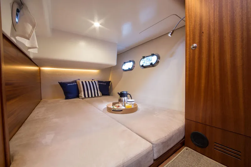  Yacht Photos Pics Luxurious cabin interior of 2026 Nimbus 405 Coup&eacute; with cozy bedding and elegant decor.