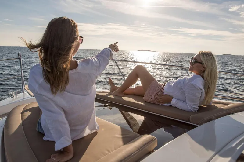  Yacht Photos Pics Women relaxing on a 2026 Nimbus 405 Coup&eacute; yacht, enjoying the ocean view.