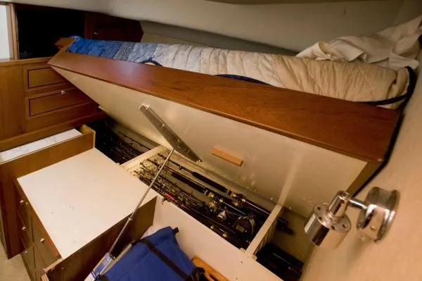 Motivator Yacht Photos Pics 1982 Pacifica Convertible interior with under-bed storage and fishing gear.