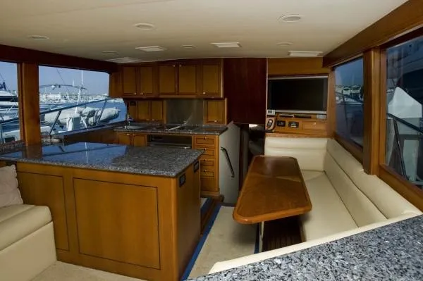 Motivator Yacht Photos Pics Luxurious interior of a 1982 Pacifica Convertible yacht with wood cabinetry and granite countertops.