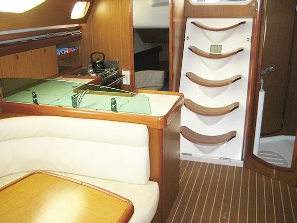 R Yacht Photos Pics Interior of 2006 Jeanneau Sun Odyssey 42 DS sailboat with wood finish and seating area.