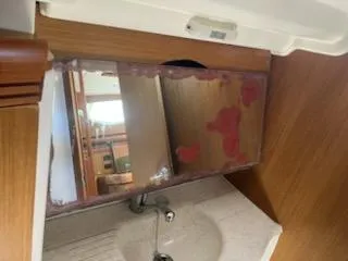 R Yacht Photos Pics Interior of 2006 Jeanneau Sun Odyssey 42 DS yacht, featuring a bathroom sink and mirror.