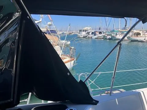 R Yacht Photos Pics Jeanneau Sun Odyssey 42 DS sailboat, 2006 model, docked in a marina with clear blue water.