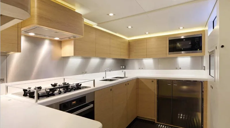 Spirit Of Malouen X Yacht Photos Pics Modern kitchen interior on 2012 Wally 107 Racer-Cruiser yacht, featuring sleek cabinetry and appliances.