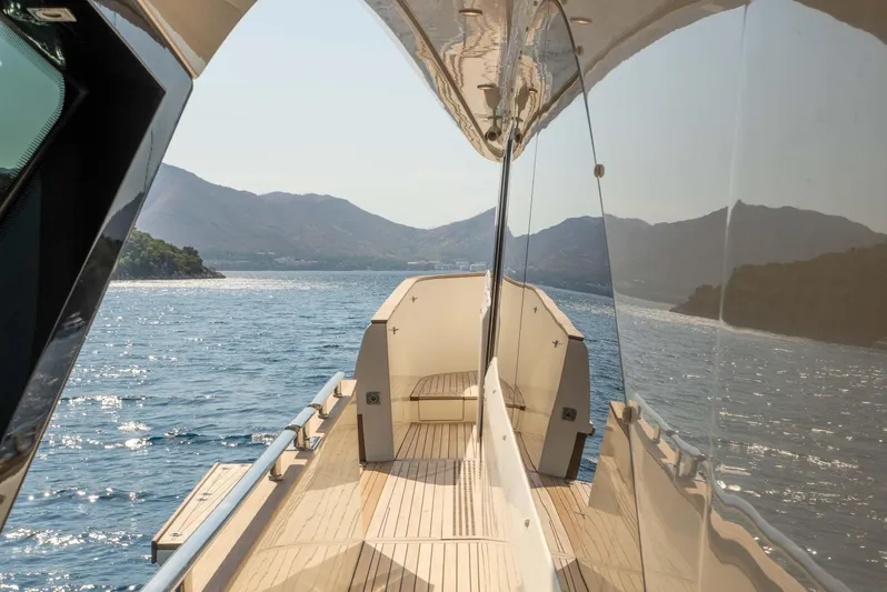  Yacht Photos Pics Luxurious Monte Carlo Yachts MCY 86, 2016 model, cruising on serene waters with scenic mountain views.