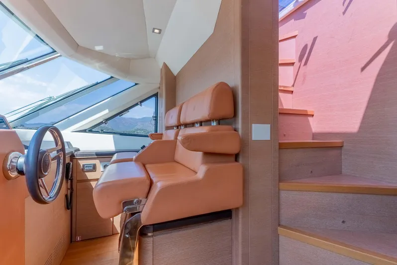  Yacht Photos Pics Interior of 2016 Monte Carlo Yachts MCY 86 with leather seating and wooden stairs.
