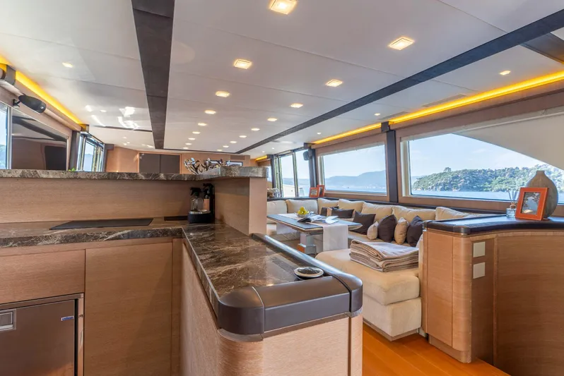  Yacht Photos Pics Luxurious interior of 2016 Monte Carlo Yachts MCY 86 with elegant furnishings and panoramic windows.